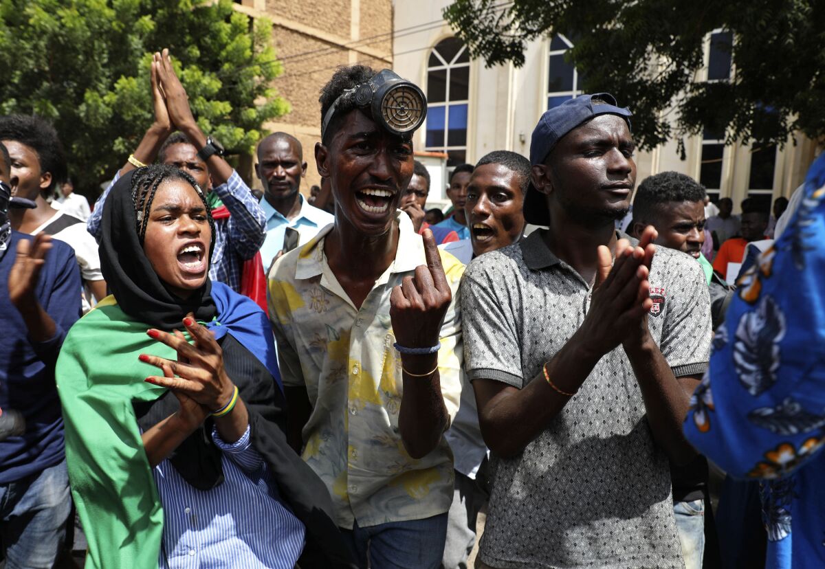 Sudanese protesters gather outside the Cabinet’s headquarters in the capital, Khartoum, Sudan, Monday, Aug. 17, 2020. The protesters returned to the streets Monday to pressure transitional authorities for more reforms, a year after a power-sharing deal between the pro-democracy movement and the generals. (AP Photo/Marwan Ali)