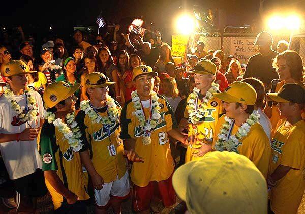 Members of the world champion Ocean View Little League team celebrate with family, friends and supporters during a homecoming celebration at their field in Huntington Beach on Monday night. The team won the Little League World Series title, 2-1, on Sunday over Hamamatsu, City, Japan, in South Williamsport, Pa.