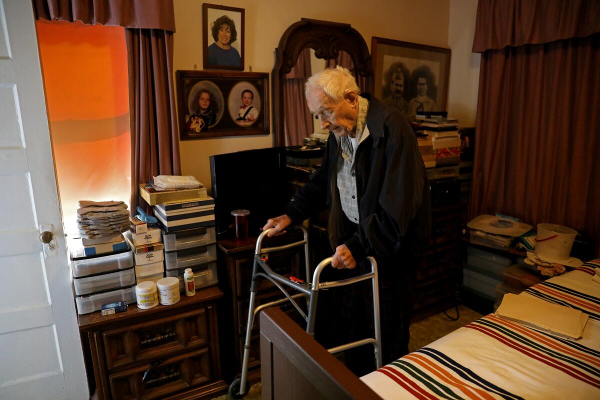 World War II veteran Paul Hult, 102, uses a walker in his Los Angeles apartment.