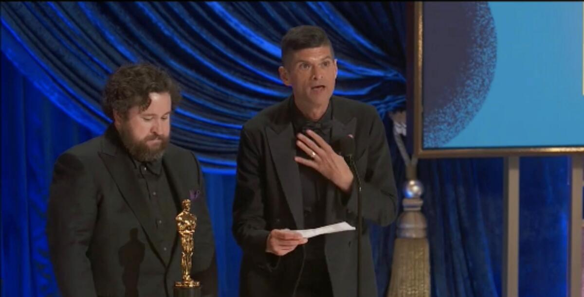 Michael Govier and Will McCormack stand with their Oscar statuette.