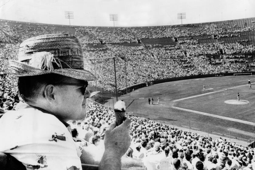 April 17, 1961: Los Angeles Dodger fan eats ice cream cone during game at the Los Angeles Memorial Coliseum.