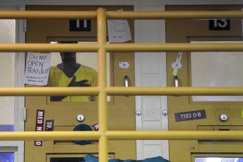 An inmate stands in his cell in an area reserved for the mentally ill at L.A. County's Twin Towers correctional facility. Federal officials announced they would move forward with oversight of the jails.