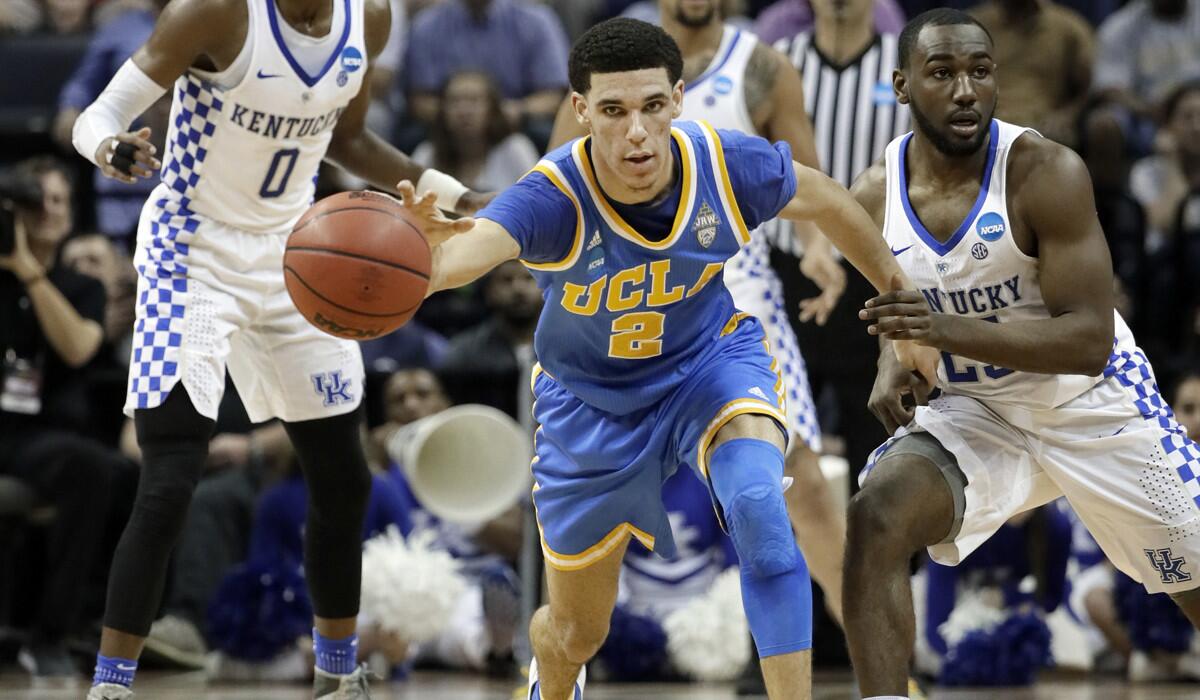 UCLA guard Lonzo Ball dribbles away from Kentucky guard Dominique Hawkins, right, in the first half of the NCAA tournament South Regional semifinal game on March 24.