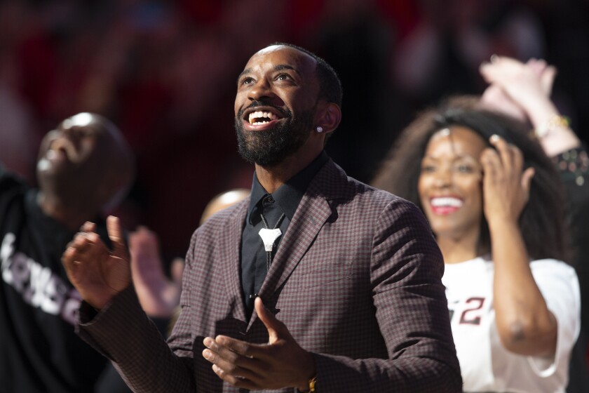 Former Louisville player Russ Smith watches as his jersey is hung in the rafters at the KFC Yum! Center during his number retirement ceremony at the NCAA college basketball game between Notre Dame and Louisville in Louisville, Ky. Saturday, Jan. 22, 2022. (Pat McDonogh/Courier Journal via AP)