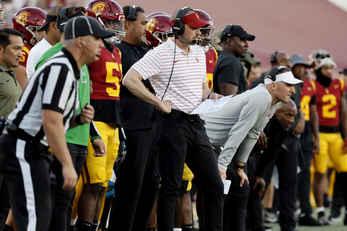USC defensive coordinator Alex Grinch, left, and head coach Lincoln Riley watch from the sideline at the Coliseum.