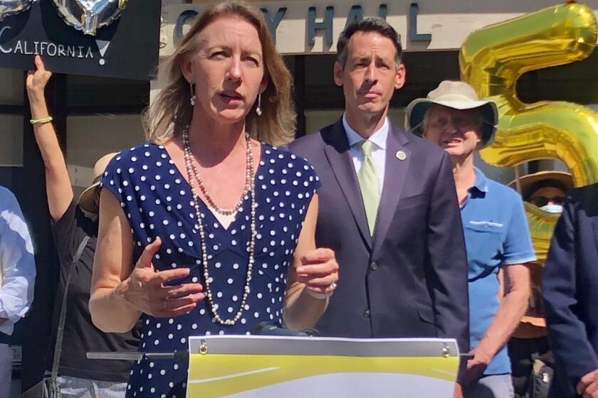 Encinitas Mayor Catherine Blakespear, with Encinitas City Council member Joe Mosca in the background.