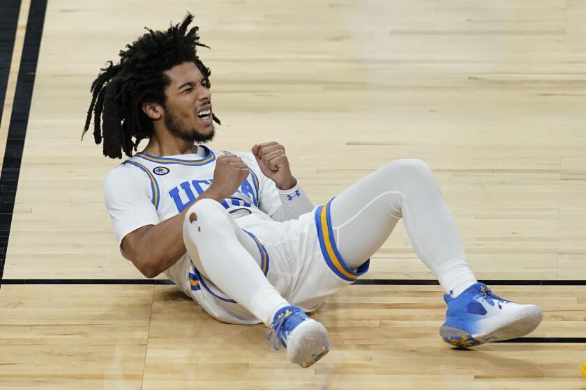 UCLA's Tyger Campbell (10) reacts after a play against Oregon State during the second half of an NCAA college basketball game in the quarterfinal round of the Pac-12 men's tournament Thursday, March 11, 2021, in Las Vegas. (AP Photo/John Locher)