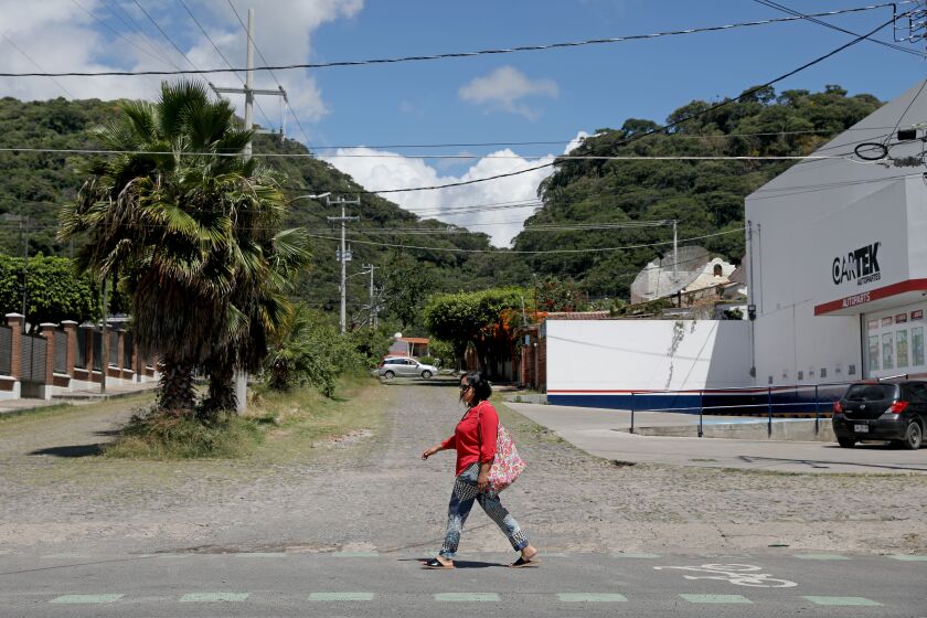 AJIJIC, JALISCO - SEPTEMBER 29: Fabiana Ramirez Flores, 51, walks home from the market on Wednesday, Sept. 29, 2021 in Ajijic, Jalisco. Fabiana Ramirez Flores, 51, who is undocumented, was the first woman to come forward after being sexually assaulted by Dr. Esmail Nadjmabadi in 2005. He threatened to call ICE on her if she didn't withdraw her complaint. Fabiana lives with her husband Carlos Valle Perez, 53, in Ajiijic, Mexico. (Gary Coronado / Los Angeles Times)