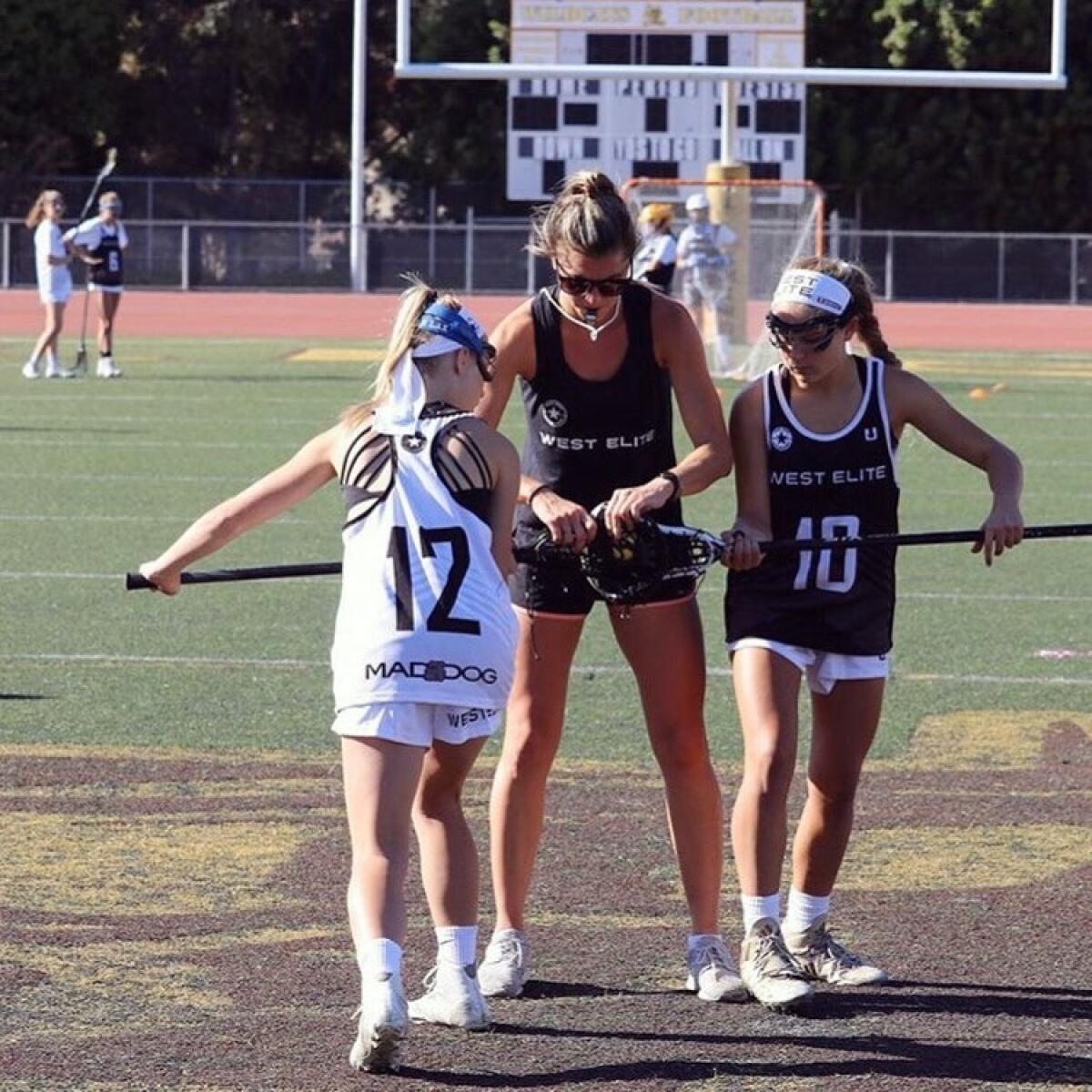 Kelsey Cuje on a field coaching.