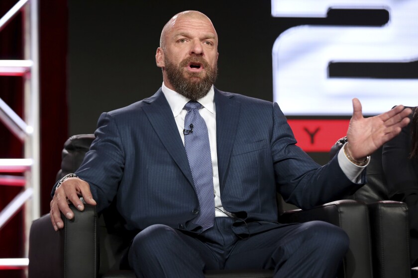 FILE - In this Jan. 9, 2018, file photo, Paul "Triple H" Levesque participates in the "WWE Monday Night Raw: 25th Anniversary" panel during the NBCUniversal Television Critics Association Winter Press Tour in Pasadena, Calif. With most American sports already settled in to their old routines, WWE is set to ditch its stopgap home in Florida and resume touring starting Friday night with "Smackdown" from Houston, a pay-per-view Sunday in Texas and a return Monday to Dallas for the flagship "Raw" taping. (Photo by Willy Sanjuan/Invision/AP)