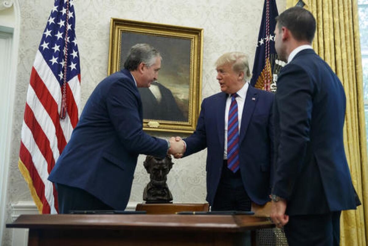 El presidente Donald Trump, acompañado por el secretario interino del Departamento de Seguridad Nacional Kevin McAleenan, derecha, estrecha la mano del ministro de Gobernación guatemalteco Enrique Degenhart en la Oficina Oval de la Casa Blanca en Washington, el viernes 26 de julio de 2019.