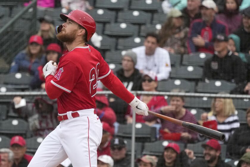 Los Angeles Angels' Jared Walsh watches the flight of his ground-rule double against the Oakland Athletics during the second inning of a spring training baseball game Tuesday, March 21, 2023, in Tempe, Ariz. (AP Photo/Ross D. Franklin)
