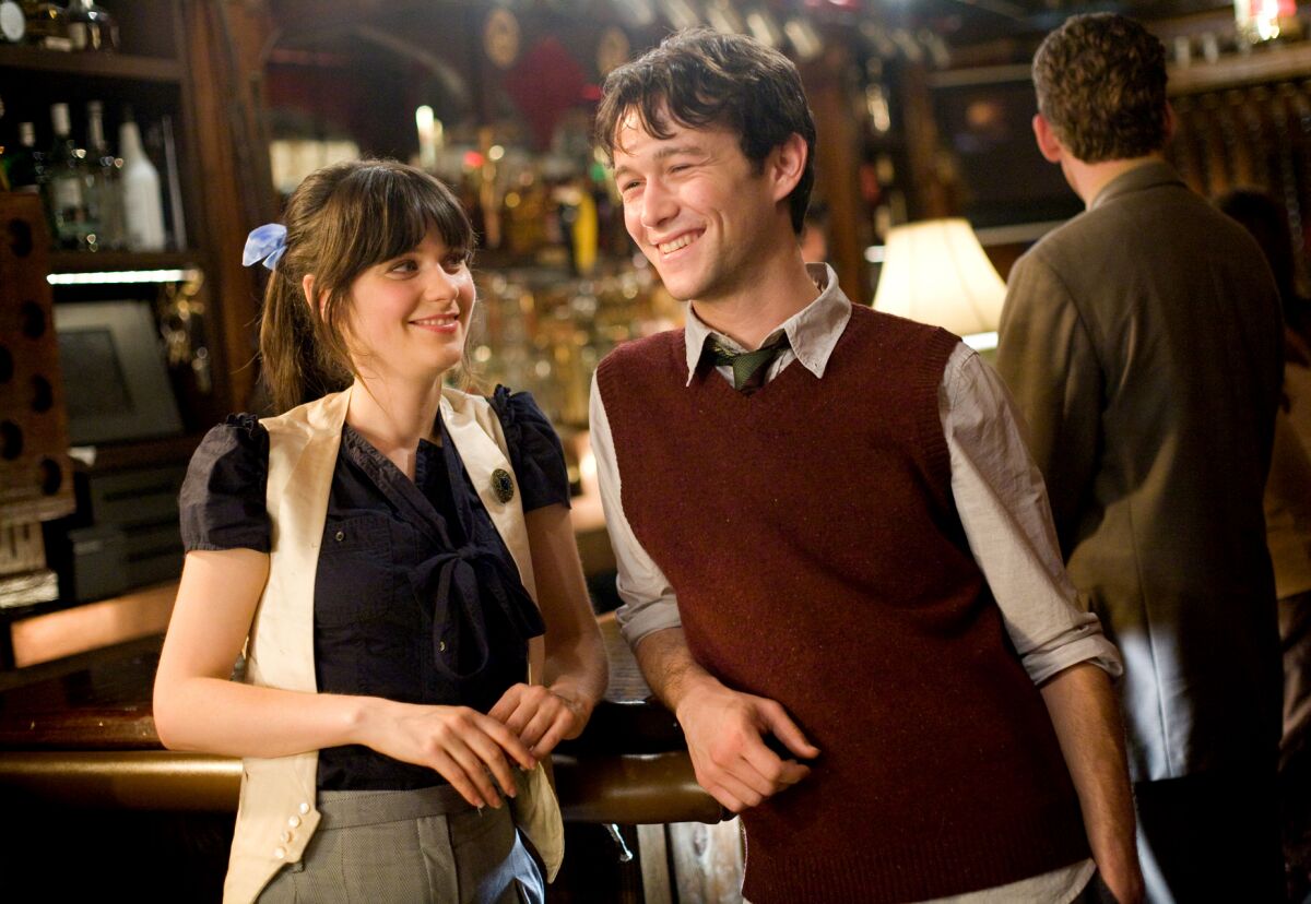 A smiling couple at a bar.