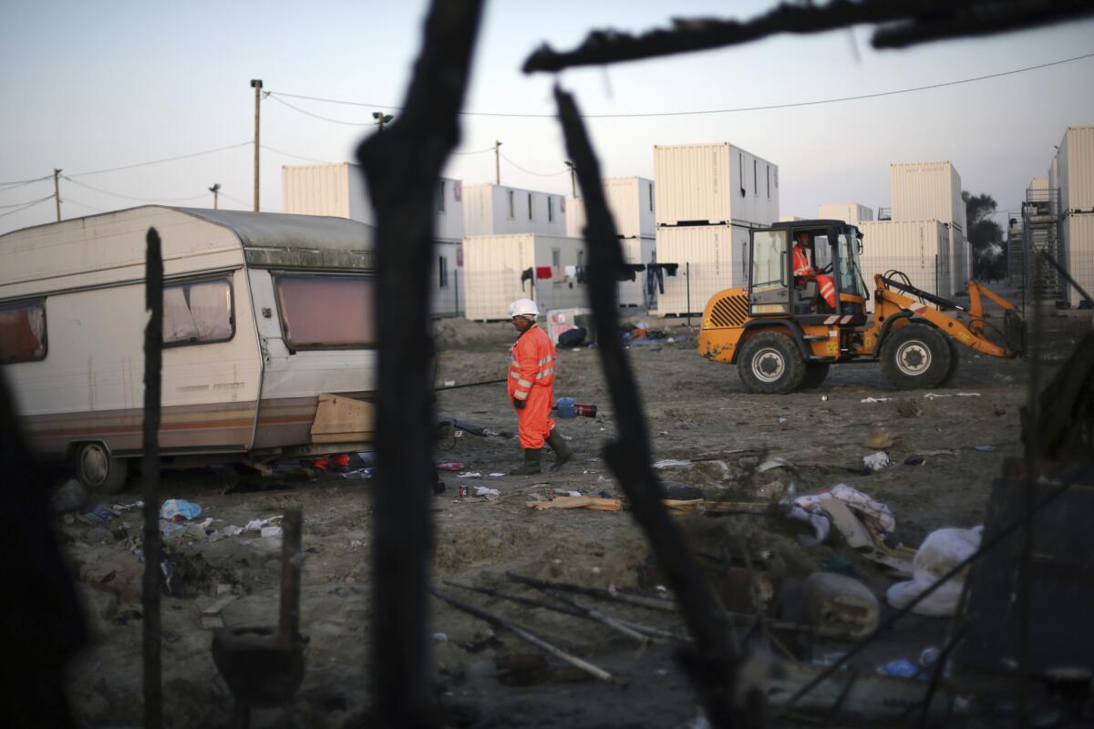 A worker walks through the remains of the migrant camp known as the jungle near Calais on France's north coast on Oct. 29.