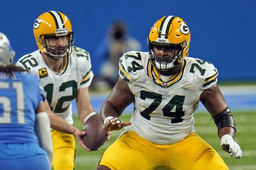 FILE - In this Dec. 13, 2020, file photo, Green Bay Packers offensive guard Elgton Jenkins looks to block during the second half of an NFL football game against the Detroit Lions in Detroit. Jenkins has spent his NFL career demonstrating he can thrive at just about every spot on the offensive line at one time or another. Now the Pro Bowl left guard looks forward to his biggest test yet as he fills in for injured All-Pro selection David Bakhtiari at left tackle and leads a Packers line that likely will include two rookie starters. (AP Photo/Paul Sancya, File)