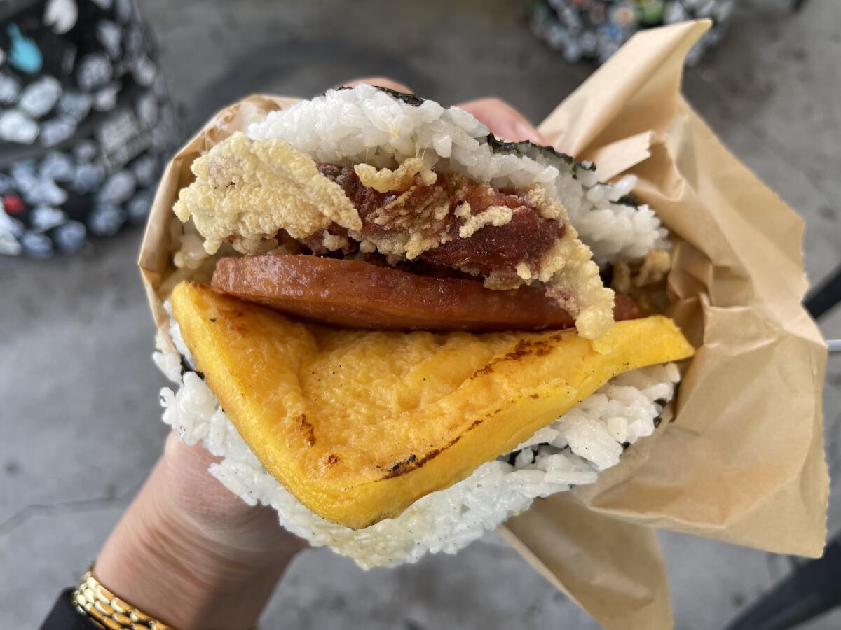 Closeup of a sandwich with rice and a seaweed wrap.