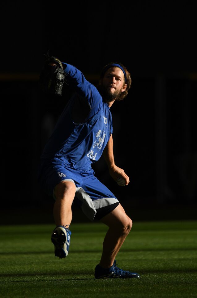 Dodgers' Clayton Kershaw works out before the start of Game 7 of the National League Championship Series against the Milwaukee Brewers at Miller Park on Saturday.