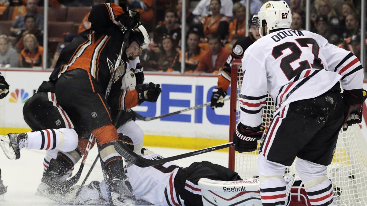 Chicago Blackhawks goalie Corey Crawford makes a save on a shot by Ducks forward Matt Beleskey, left, during the first period of Game 2 of the Western Conference finals at Honda Center on May 19, 2015.