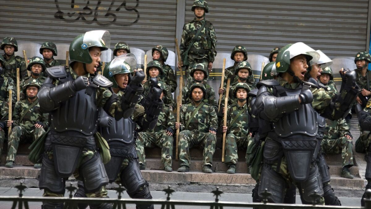 In this 2009 photo, Chinese paramilitary police practice during a break from patrol in western China's Xinjiang province.