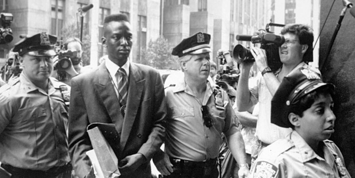 Yusef Salaam, one of the Central Park Five, is escorted by police in New York in 1990.