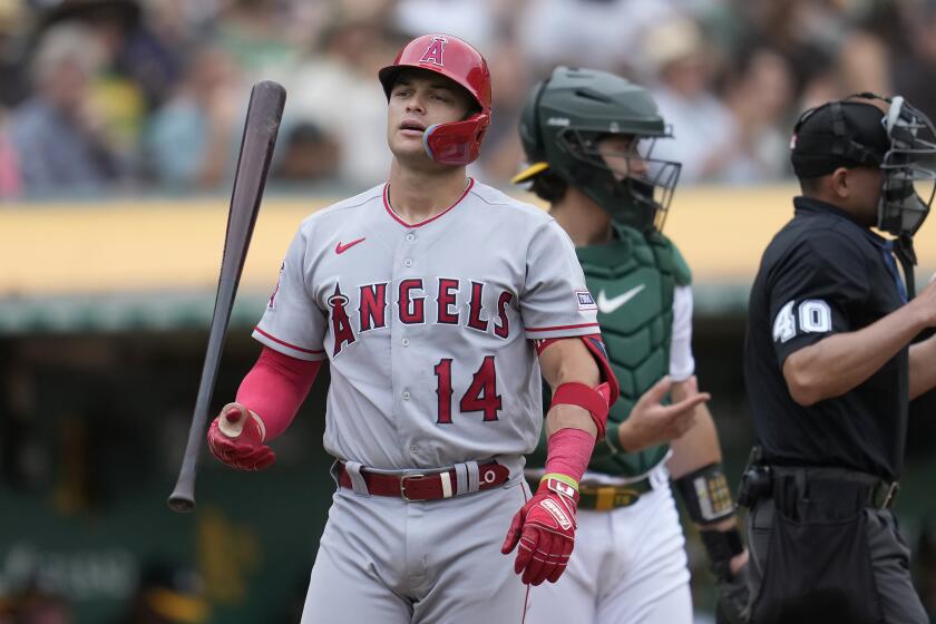 Los Angeles Angels' Logan O'Hoppe (14) walks to the dugout after striking out against the Oakland Athletics during the fourth inning of a baseball game in Oakland, Calif., Saturday, Sept. 2, 2023. (AP Photo/Jeff Chiu)