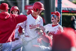 Freshman Louis Lappe of Harvard-Westlake receives congratulations after his first high school hit.