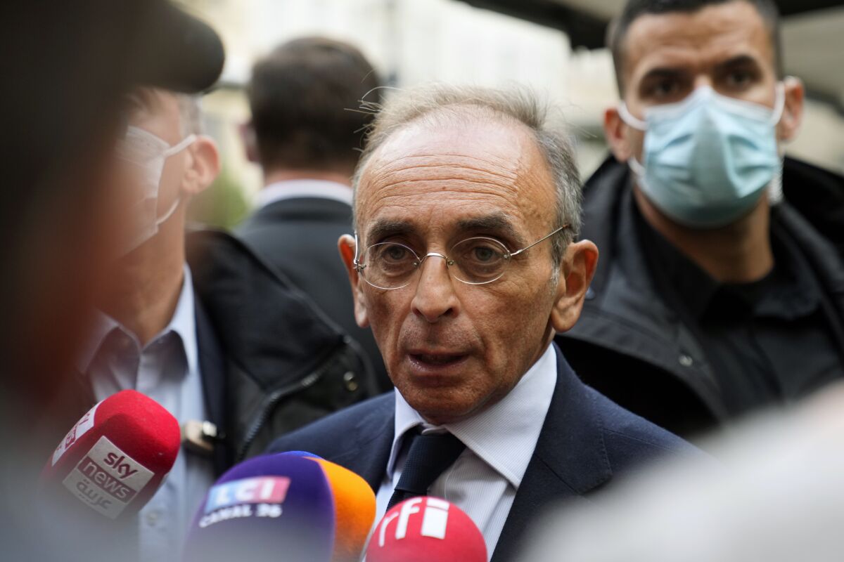 Far-right presidential candidate Eric Zemmour answers reporters prior to give a press conference at the Foreign Press Association headquarters, in Paris, Monday, Jan. 17, 2022. Zemmour was convicted Monday of inciting racial hatred over 2020 comments he made about unaccompanied migrant children. A Paris court ordered Zemmour to pay a fine of 10,000 euros (more than $11,000) and several thousand euros in damages to anti-racism groups. (AP Photo/Francois Mori)