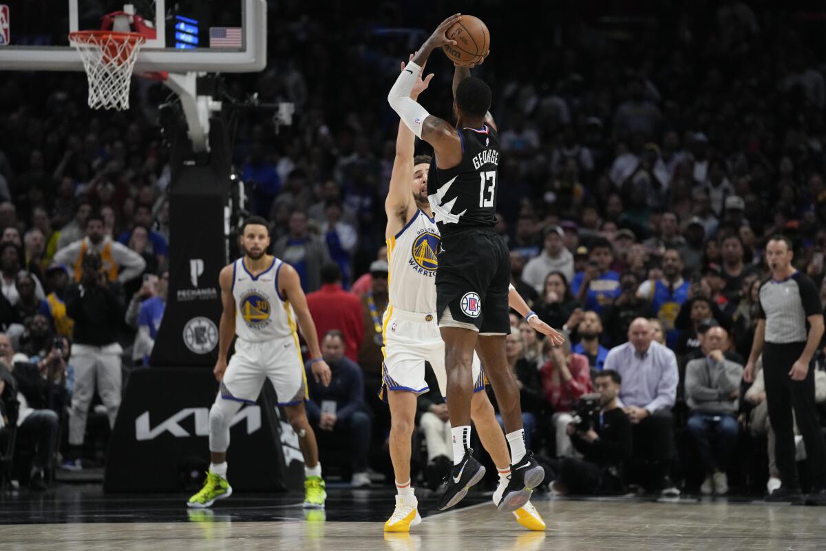 Clippers forward Paul George (13) elevates for a winning three-pointer against Warriors guard Klay Thompson.