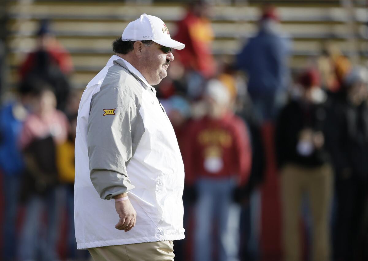 Iowa State offensive coordinator Mark Mangino walking on the field before a game against West Virginia in 2014.