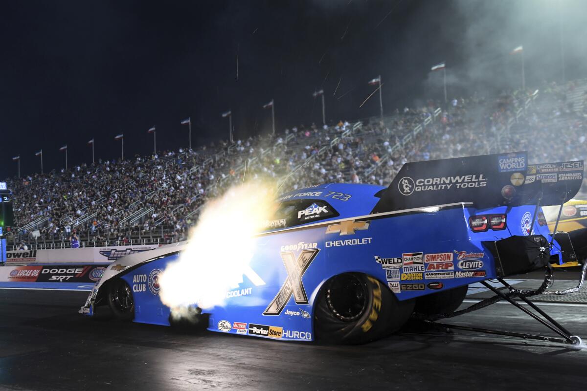 In this photo provided by the NHRA, John Force powers his Funny Car to kick off qualifying at the NHRA U.S. Nationals drag races at Lucas Oil Raceway in Brownsburg, Ind., Friday, Sept. 3, 2021. (Marc Gewertz/NHRA via AP)
