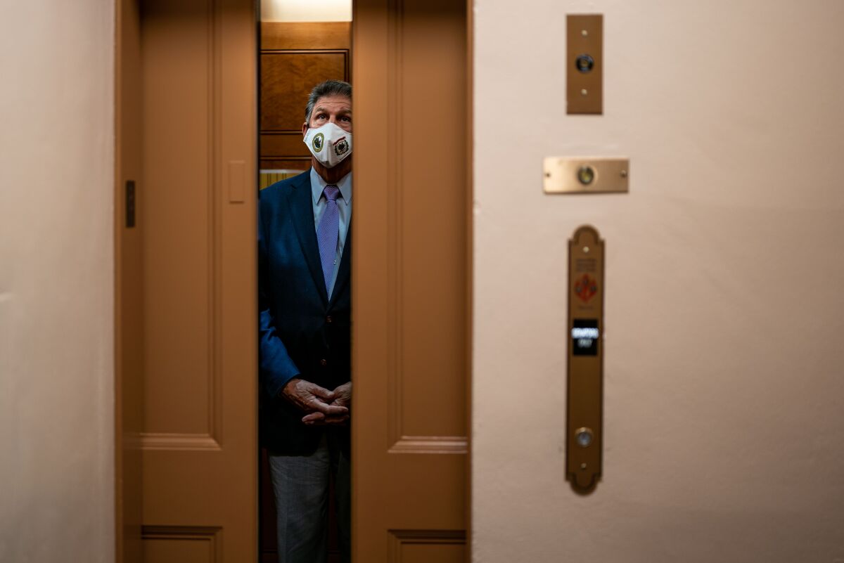 Sen. Joe Manchin (D-W.Va.) stands in an elevator near the Senate Subway on Capitol Hill on Aug. 5.