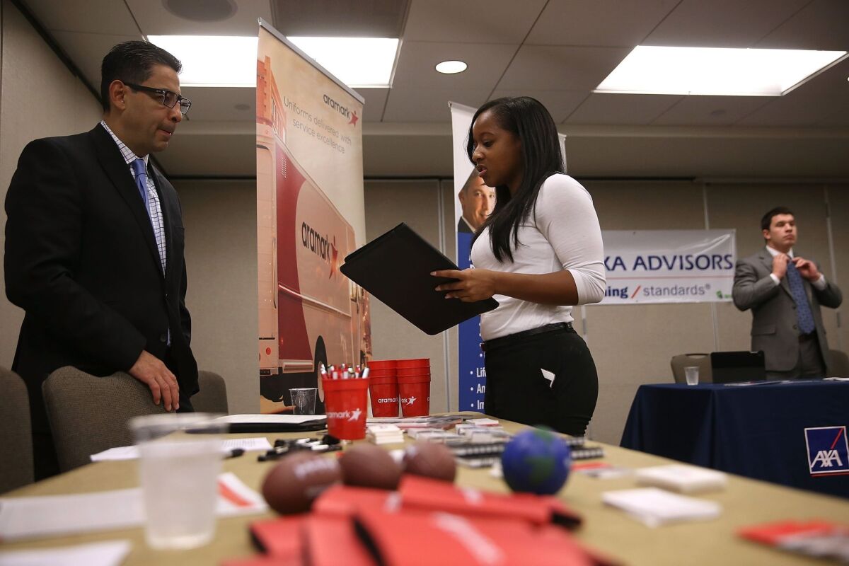 A job seeker meets with a recruiter during a HireLive career fair in San Francisco earlier this summer.