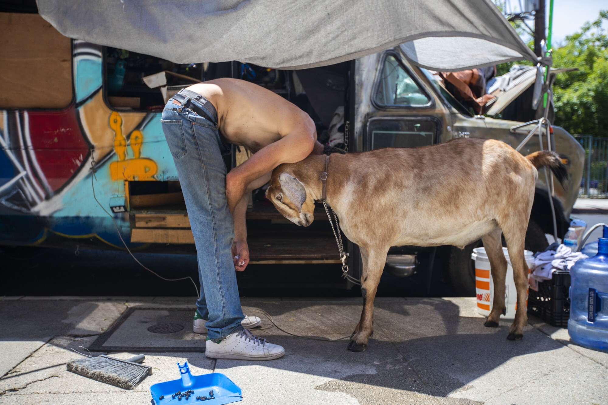 A man stands with his goat