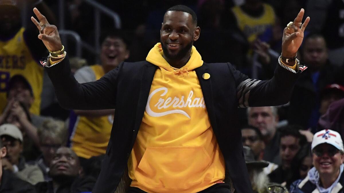 Lakers star LeBron James celebrates from the bench during a game against the Clippers in April. Will the No. 4 overall pick in the NBA draft help the team rediscover its championship form?