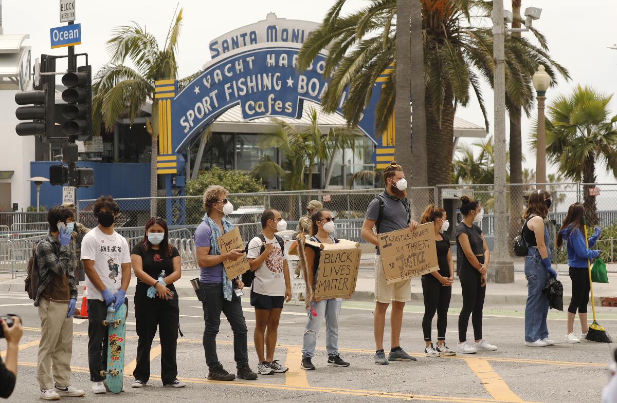 Protesters stand near Santa Monica Pier in June, after the deaths of Breonna Taylor, Ahmaud Arbery and George Floyd.