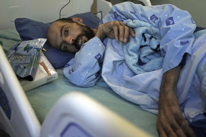 FILE - Khalil Awawdeh, a Palestinian prisoner on a hunger strike lies in bed at Asaf Harofeh Hospital in Be'er Ya'akov, Israel, Aug. 24, 2022. HaMoked, an Israeli rights group said Sunday, Oct. 2, 2022, that Israel is holding nearly 800 Palestinians without trial or charge in so-called administrative detention, the highest number since 2008. Under the practice, prisoners can be held for months, do not know the charges against them and are not granted access to the evidence against them. (AP Photo/ Mahmoud Illean, File)