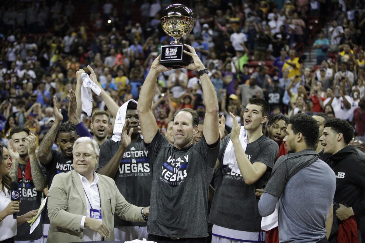 Los Angeles Lakers coach Jud Buechler holds up a trophy after the Lakers defeated the Portland Trail Blazers 110-98 in the NBA summer league championship basketball game, Monday, July 17, 2017, in Las Vegas.