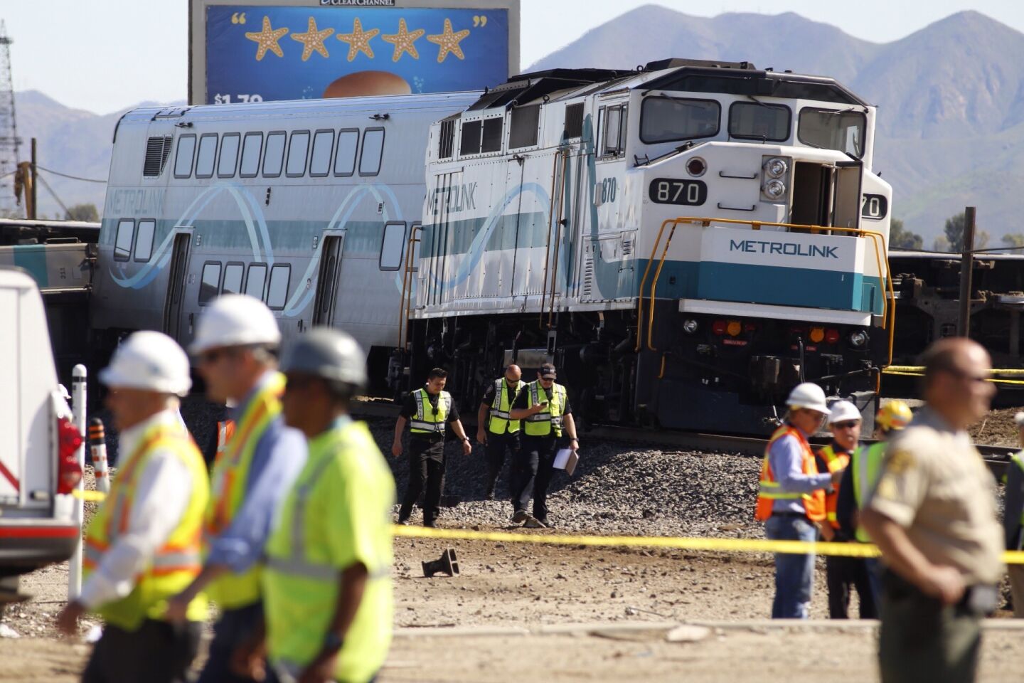 Ventura County first responders at the scene of an overturned Metrolink train car in Oxnard Tuesday, after it collided with a vehicle on the tracks.