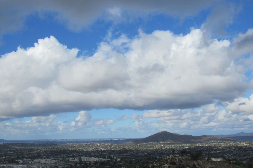 High clouds and clear skies around Cowles Mountain in the city of San Diego as seen from Mount Helix.