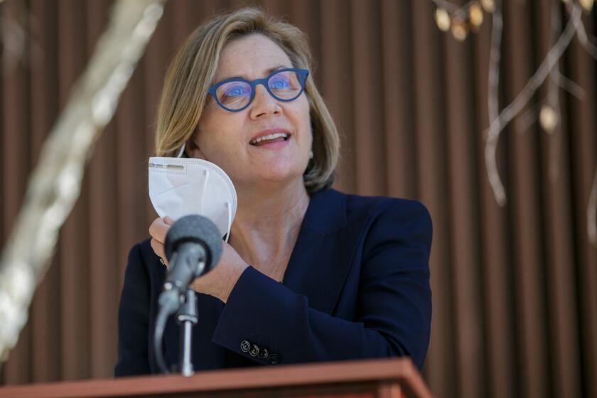 SAN JOSE, CA - NOVEMBER 10: Dr. Sara Cody, Santa Clara County, Health Officer and Director of Public Health removes a mask before speaking during a news conference in San Jose, Calif., on Wednesday, Nov. 10, 2021. In advance of the holidays, county health officials are saying the COVID-19 booster shot is appropriate for almost everyone 18 and older and are urging all residents that meet the guidelines get a booster shot. (Anda Chu/Bay Area News Group)