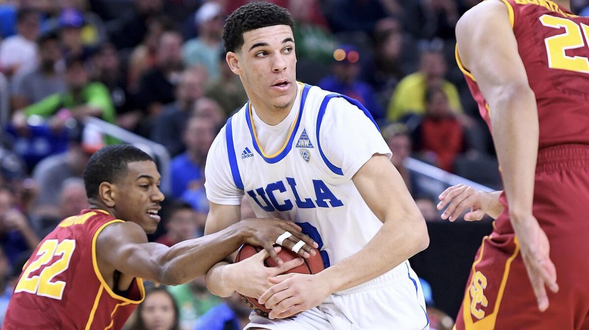 UCLA guard Lonzo Ball picks up a loose ball in front of USC guard De'Anthony Melton during a Pac-12 tournament game at T-Mobile Arena on March 9.