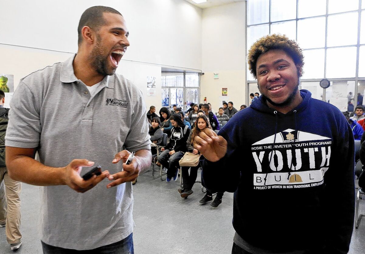 Prophet Walker, left, a candidate for state Assembly, shares an upbeat moment with Jonathan Chase Butler, 19, after speaking to students at Compton YouthBuild.