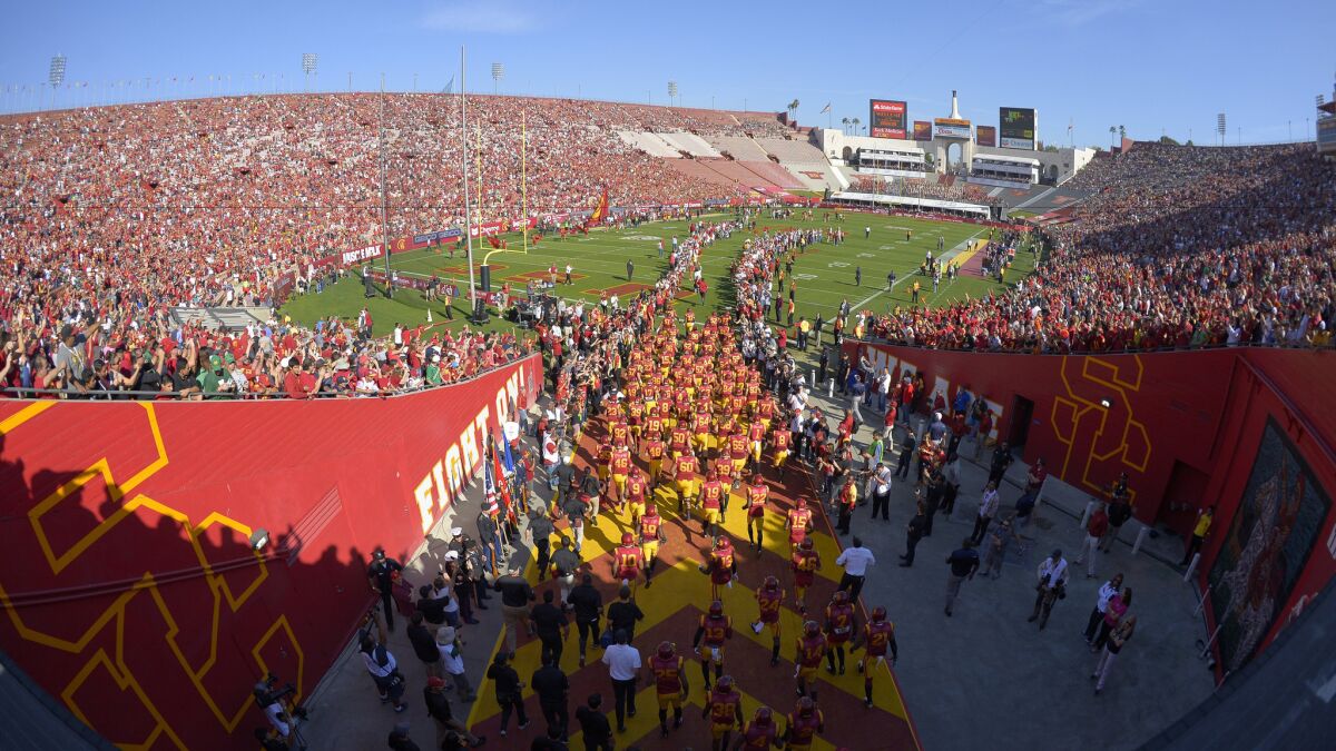 The USC Trojans take the field for a 2014 game against Notre Dame at the Coliseum.