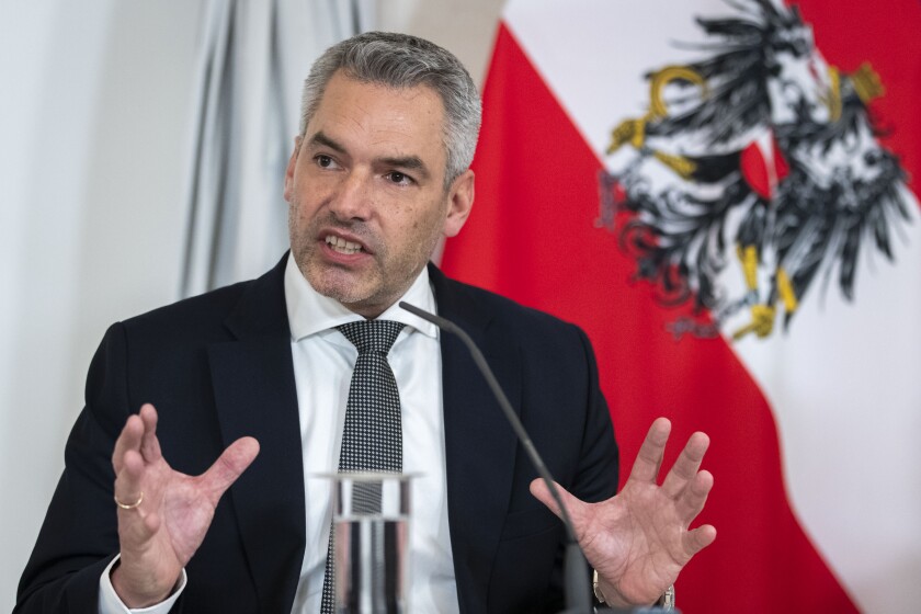 Austrian Chancellor Karl Nehammer presents the new COVID19- regulations at a press conference after a meeting of the federal government in Vienna, Austria, Thursday, Jan. 6, 2022. The new regulations will come into force on Monday, Jan. 10, 2022. (AP Photo/Lisa Leutner)