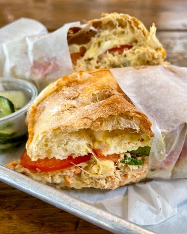 The paper-wrapped tuna melt at Joan's on Third, served on a ciabatta roll with jack cheese.