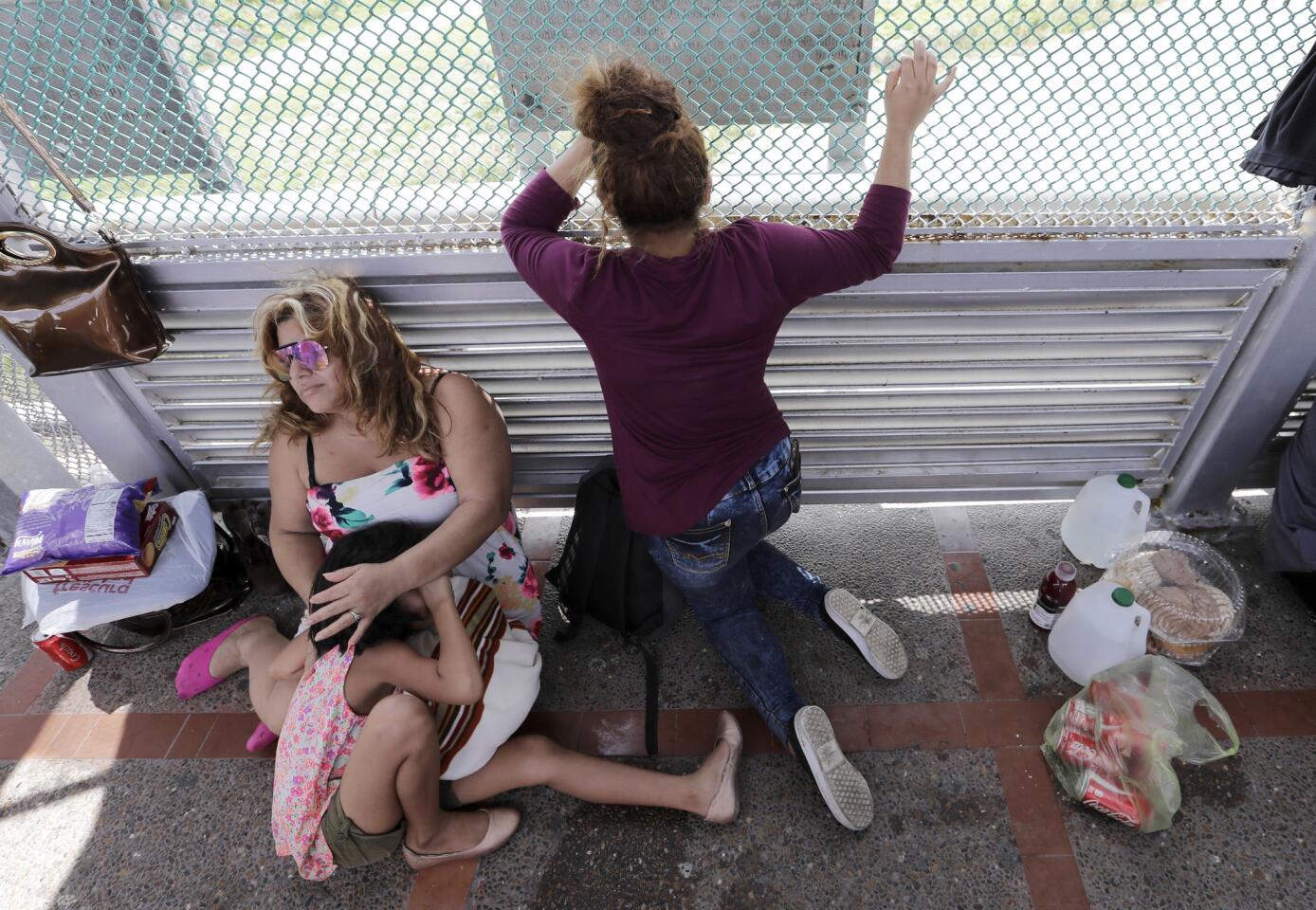 Immigrants from Honduras seeking asylum wait on the Gateway International Bridge, which connects the United States and Mexico, in Matamoros, Mexico, on June 24, 2018. The family has been waiting two days on the bridge.