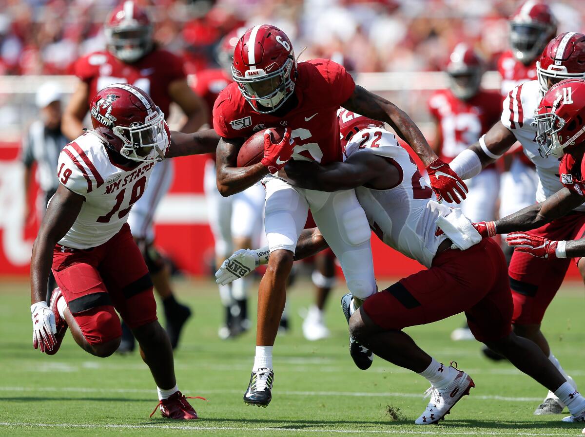 Alabama wide receiver DeVonta Smith tries to break a tackle during a win over New Mexico State.
