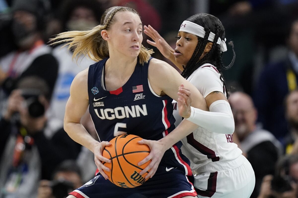 UConn's Paige Bueckers tries to get past South Carolina's Destanni Henderson during the first half of a college basketball game in the final round of the Women's Final Four NCAA tournament Sunday, April 3, 2022, in Minneapolis. (AP Photo/Charlie Neibergall)