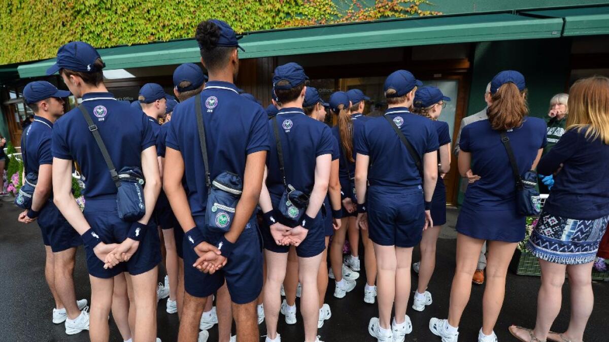 Ball boys and girls wait to be assigned matches on July 1 at Wimbledon.