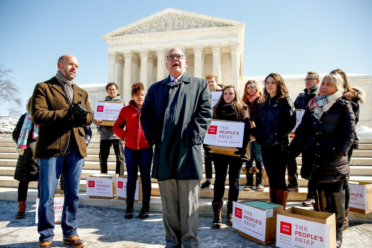 Jim Obergefell, center, speaks to members of the media in front of the U.S. Supreme Court on Friday, March 6.